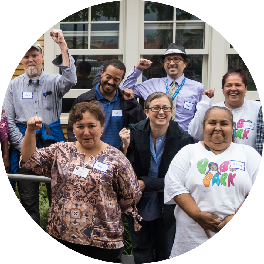 Group of happy people with hands in the air from the Urban Greening program in Richmond, California